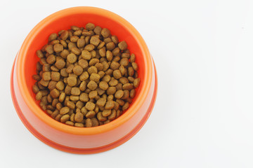 One color animal food or kibble inside a red animal bowl on isolated white background