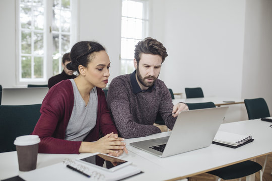 Man and Woman Working Together in Office