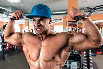 man in blue cap doing biceps exercises