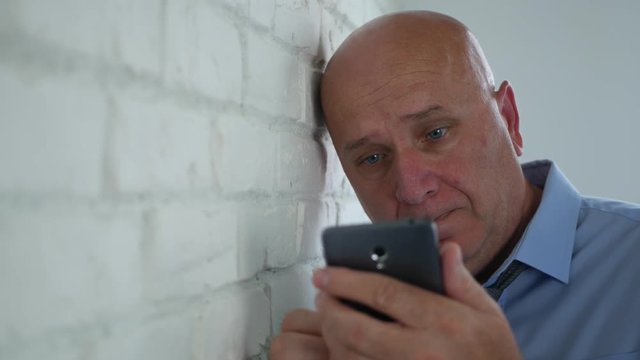 Disappointed Businessman Image in Office After Reading Bad News on Cell Phone