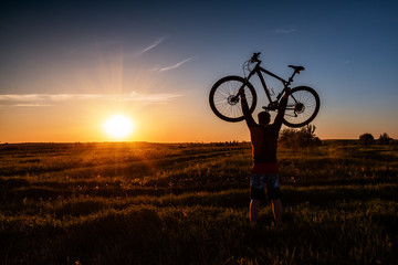 Fototapeta na wymiar silhouette of a man with a bicycle