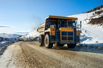 Yellow dump truck on a road