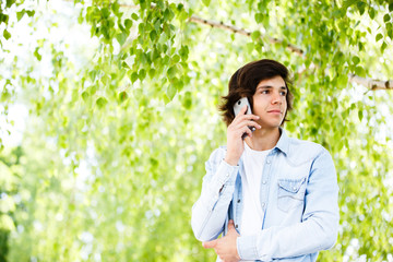 Young man talking on phone while standing outdoor