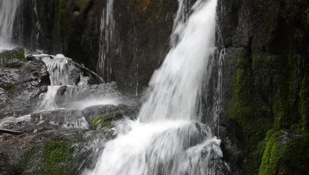 water flow on rocks of Skakalo waterfall. beautiful summer scenery of Carpathian nature. closeup detail view with polarizing effect