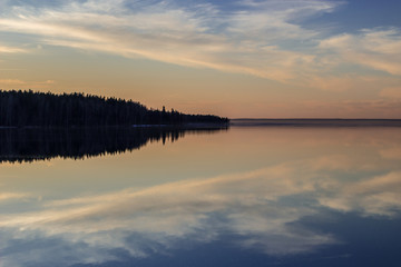 Beautiful sunset with the reflection of the sky and the background of the island