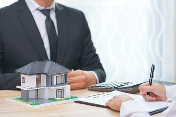 A woman customer sign loan contract and businessman waiting.