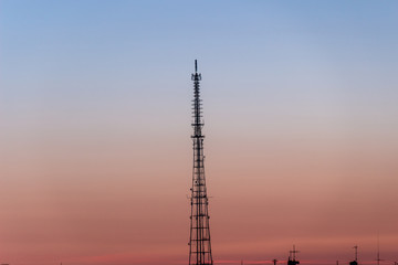 Obraz premium TV tower in the background of the city and sunset