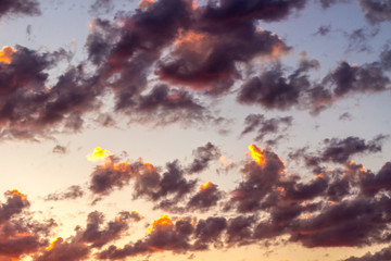 Obraz na płótnie Canvas Purple clouds illuminated by the fiery sun