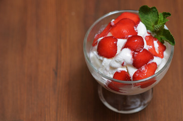 Delicious ice cream with strawberries and mint leaves