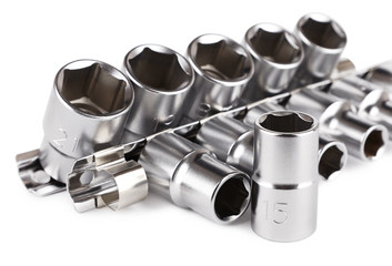 Socket set on the rail, auto mechanic tools on a light background