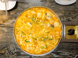 Cheesy Tokbokki korean traditional food on wood background.