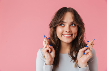 Happy young pretty woman make hopeful gesture.