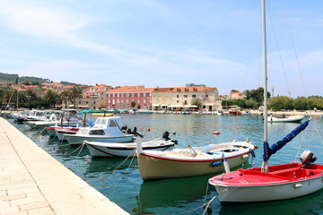 Fototapeta na wymiar Colorful boats in port of Supetar, Brac island, Croatia. Supetar is popular summer travel destination.