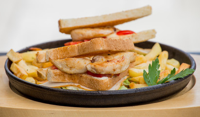 Chicken sandwich in toast bread, with French fries as a bowl, on a white background, restaurant, served