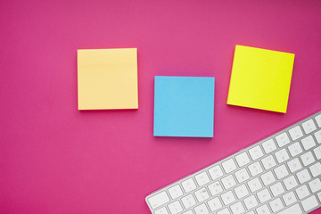 Set of colorful stickers, white keyboard, notebook and snacks. Office table, desk with different objects. Working process. Education, business concept.