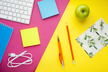 Set of colorful stickers, white keyboard, notebook and snacks. Office table, desk with different objects. Working process. Education, business concept.