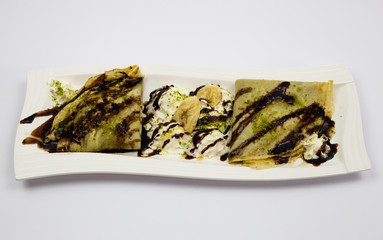 Dessert, pancakes with chocolate, and whipped cream, decorated pancakes, restaurant, served on a plate