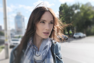 Street portrait of a young woman in wind