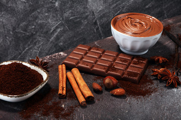 Chocolate bars on table with chocolate powder.