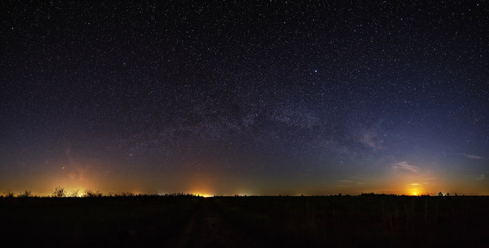 Space with the stars of the Milky Way in the night sky. Panoramic view is photographed on long exposure.