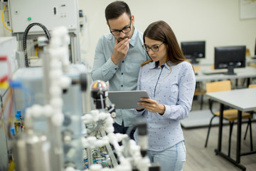 Young couple of students at robotics lab