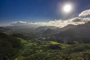 Fototapeta premium sunset on tenerife island with view on villages on slope and teide volcano