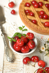 Naklejka na ściany i meble cherry tart with fruits around on white table