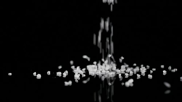 coarse sea salt crystal falling on black background