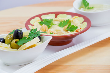 Traditional Arabic breakfast, lettuce, eggs, cheese, olives, and decorative vegetables, served on a plate, restaurant, service