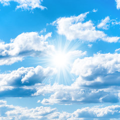Naklejka na ściany i meble Sun on blue sky with clouds as nature background