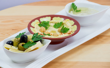 Traditional Arabic breakfast, lettuce, eggs, cheese, olives, and decorative vegetables, served on a plate, restaurant, service