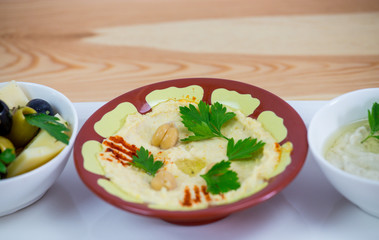 Traditional Arabic breakfast, lettuce, eggs, cheese, olives, and decorative vegetables, served on a plate, restaurant, service