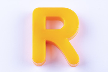 letter R uppercase alphabet isolated made of plastic on white background with shadows