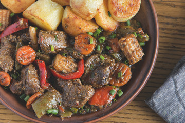 beef stew with vegetables and fried potatoes