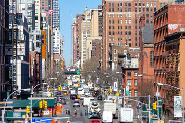 Overhead view down 10th Avenue with people and cars lining the streets through the Chelsea...