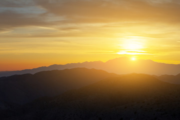 Sunlight shining over a colorful desert mountain landscape in California