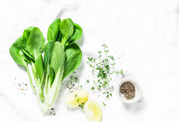 Food background with cabbage bok choi, lemon, pepper and free space for text. White background, top view