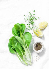 Food background with cabbage bok choi, lemon, pepper and free space for text. White background, top view