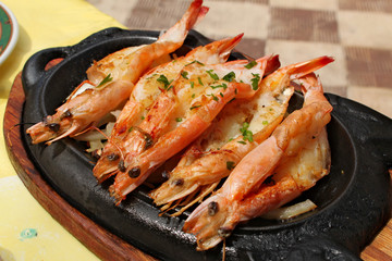 Baked royal prawns served on a hot plate