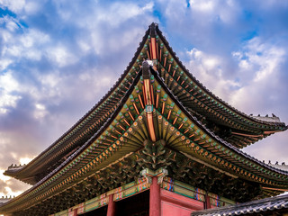 Fototapeta na wymiar The main gate at Changdeokgung Palace sunshine lighting blue sky is a famous tourist attraction in Seoul, South Korea.