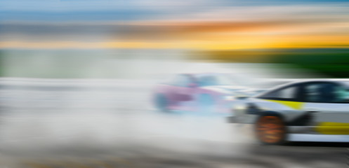 Car drifting battle, Blurred of image diffusion race drift car with lots of smoke from burning tires on speed track - 207307683