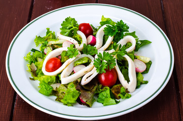 Dishes with seafood. Salad with squid
