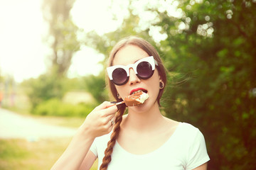 Young woman eating ice cream outdoor