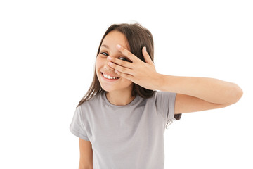 Fototapeta premium Cute girl covering eyes with hands looking camera.