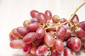 Red grapes on wooden floor