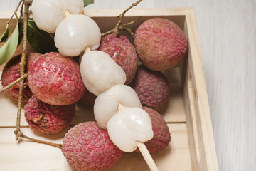 fresh lychees in a wooden box