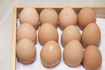 Many eggs are on wooden boxes.