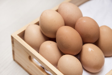 Many eggs are on wooden boxes.