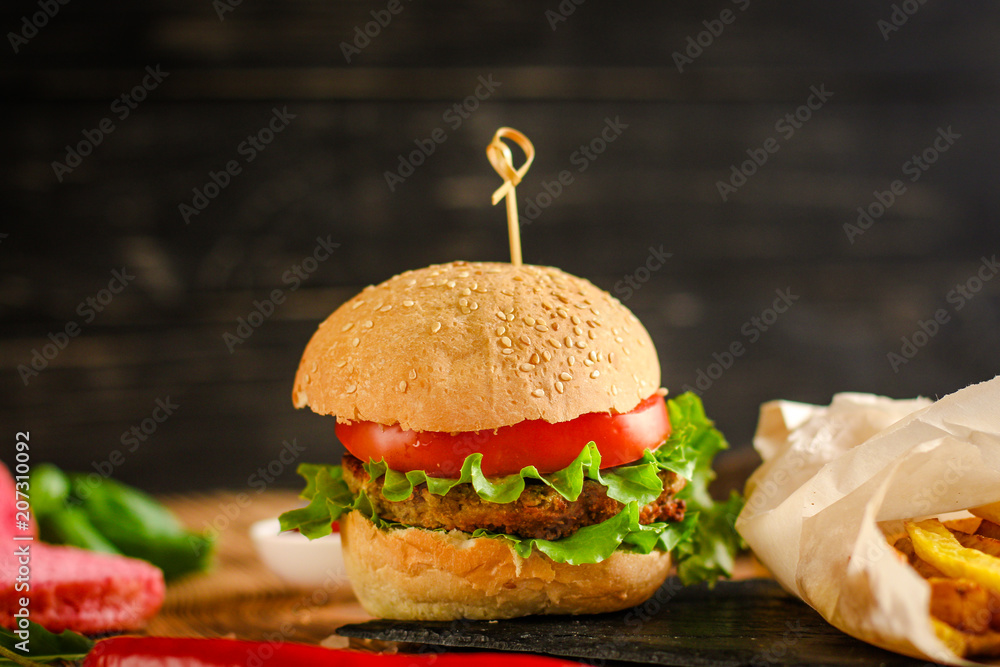 Wall mural burgers with meat, tomato and lettuce leaves  - fast food (sandwich) - cuisine.  Food background