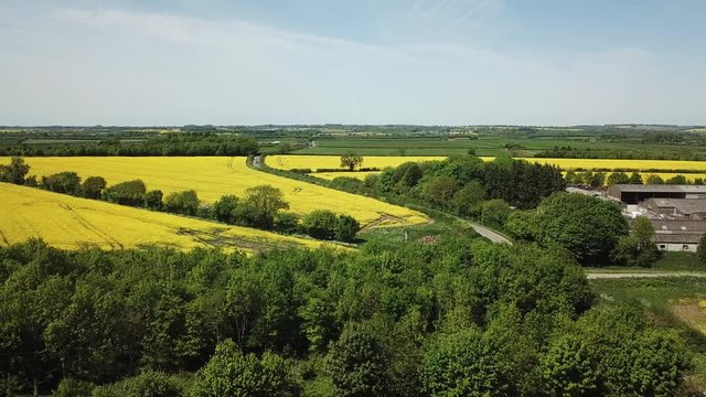Aerial of yellow rapeseed fields on the Cotswold hills in England